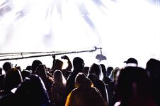 Silhouettes Of Concert Crowd In Front Of Stage Lights Stock Photos