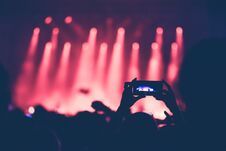 Hands Using Camera Phone To Take Pictures, Videos At Concert Stock Photos