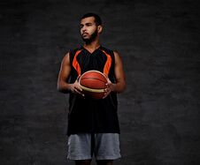 Young African-American Basketball Player In Sportswear Over Dark Background. Stock Images