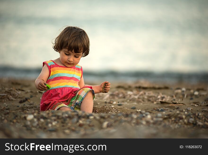 Toddler Baby Playing On A Beach