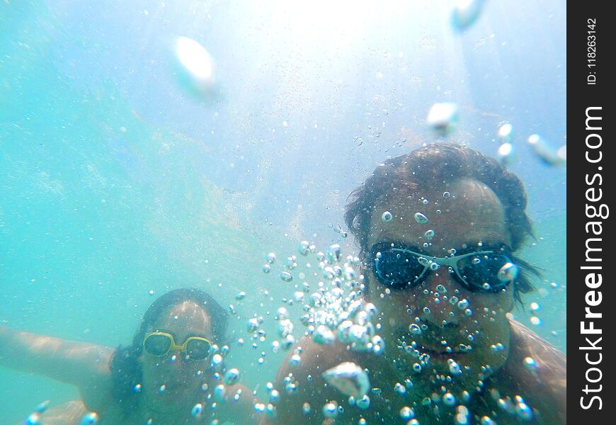 Couple Having Fun Underwater In The Sea