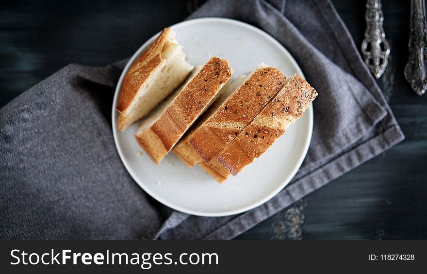 Morning breakfast table and homemade Bread in the dish. black table folk knife