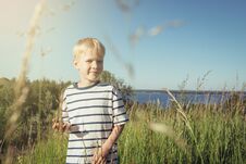 Little Boy Smiling And Looking At Camera On Nature. Stock Photo
