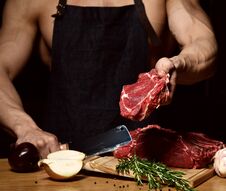 Strong Sport Man Prepare Cook Beef Steak Ribs On Dark Kitchen Background Healthy Eating Concept On Black Royalty Free Stock Photos