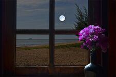 Full Moon Over The Sea In Resort Window Royalty Free Stock Photos