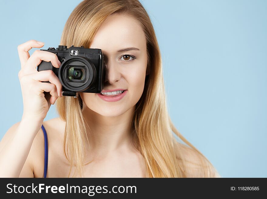 Blonde Woman With Camera On Blue