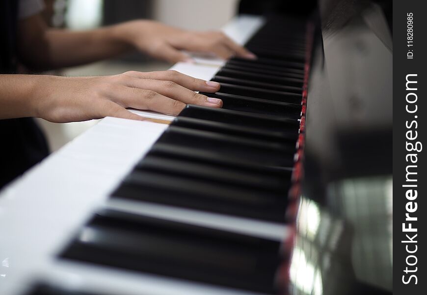 Close up of child hand on piano keys playing