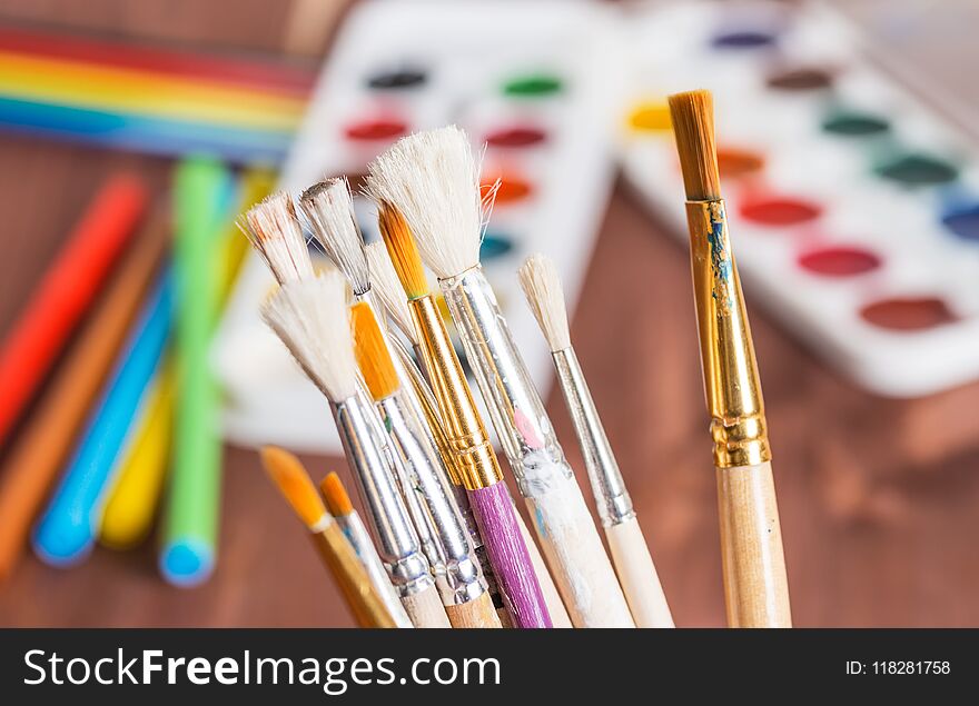 Cup with brushes on a blurred background. Cup with brushes on a blurred background