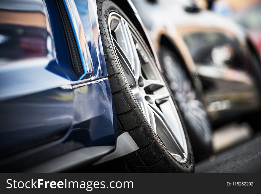 Car Alloy Wheels Closeup. Modern Vehicles on the Parking. Tire Closeup. Transportation Theme.