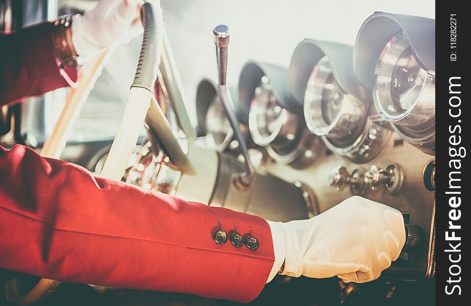 Classic Car Driving Theme. Caucasian Men Wearing White Gloves Taking Vintage Collectible Car on the Test Ride. Hand on the Steering Wheel Closeup Photo.