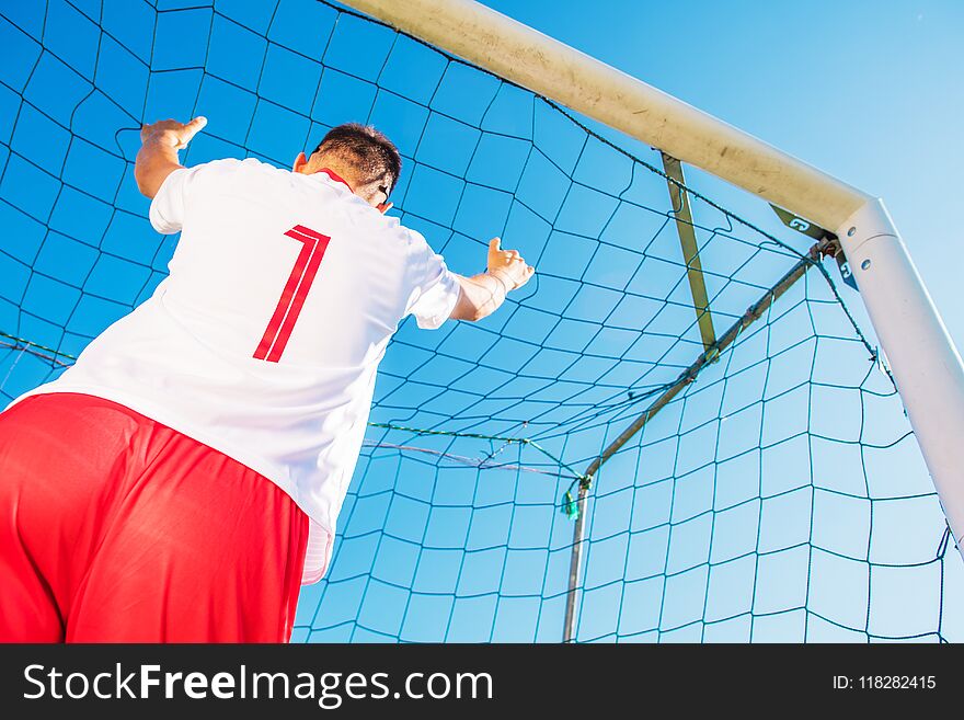 Goalkeeper with Number One on the Tshirt in the Goal. European Football Theme. Soccer Playing. Goalkeeper with Number One on the Tshirt in the Goal. European Football Theme. Soccer Playing.