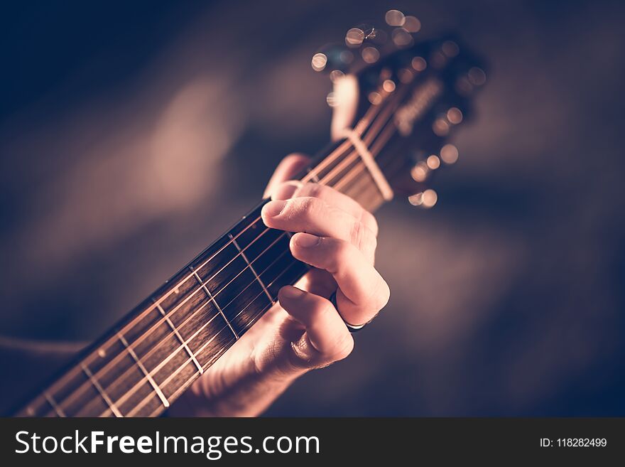 Learning Acoustic Guitar. Hands on the String Instrument Closeup Photo.