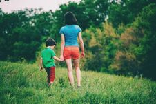 The Boy Walks With His Mother In The Meadow. Stock Photos The Boy Walks With His Mother In The Meadow. Stock Photos