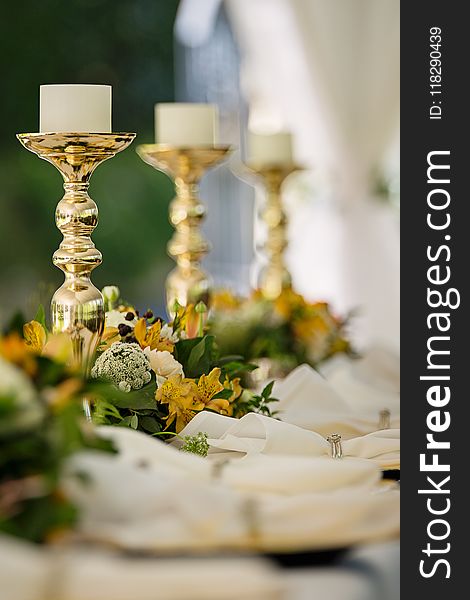 Selective Focus Photography of Gold Candlestick on Table