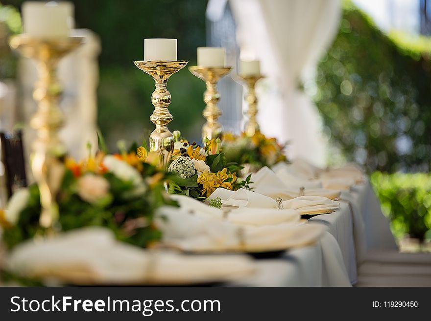 Four White Tealight Candles on Brass-colored Candlesticks