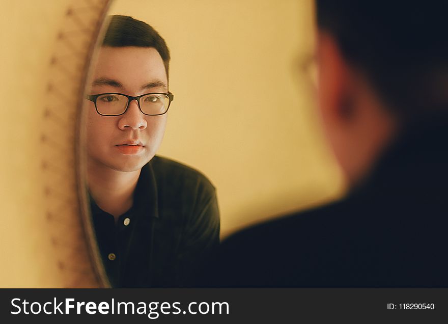 Photo of Man Looking at the Mirror