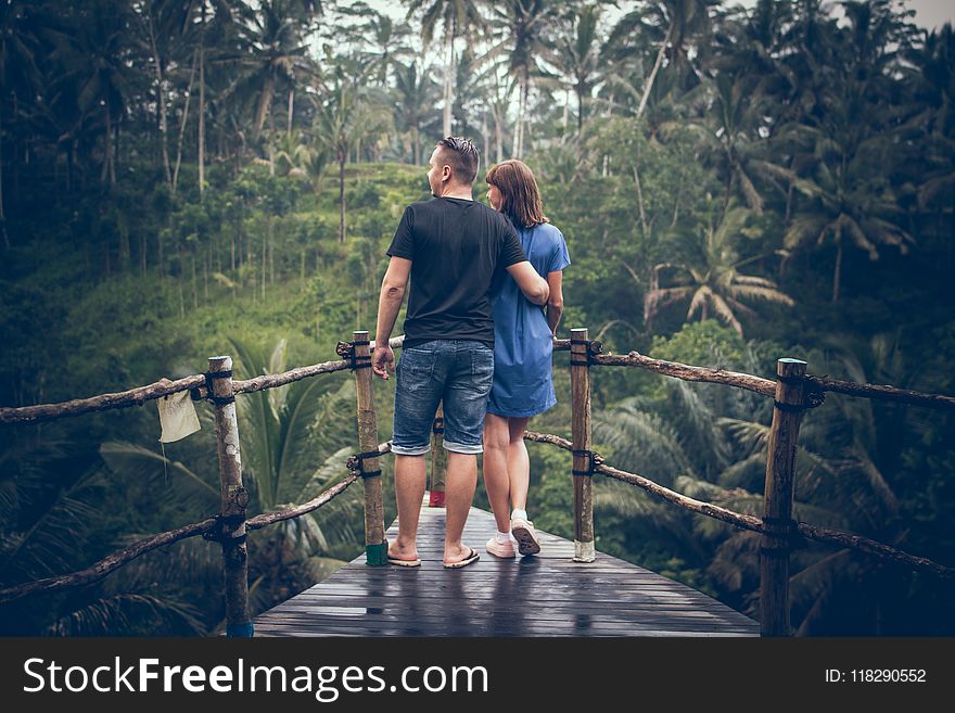 Man And Woman Standing On Hanging Bridge