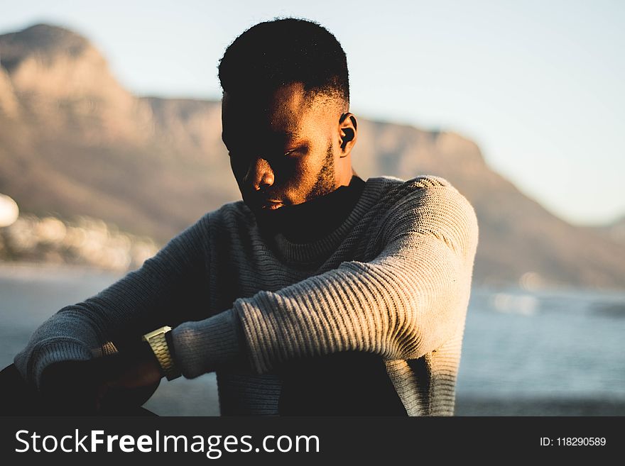 Man Wearing Gray Sweater in Selective Focus Photography