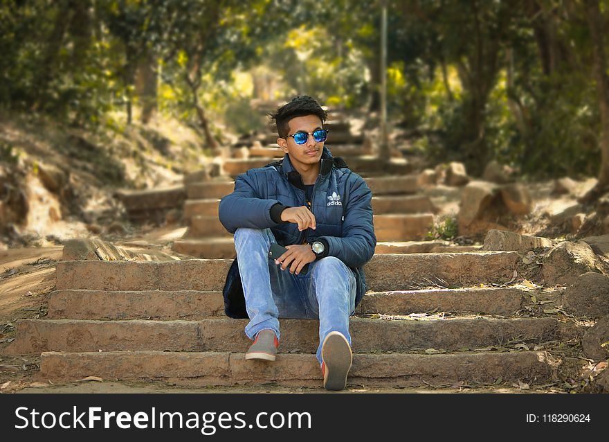 Man Wearing Blue Jacket Sitting Stairs