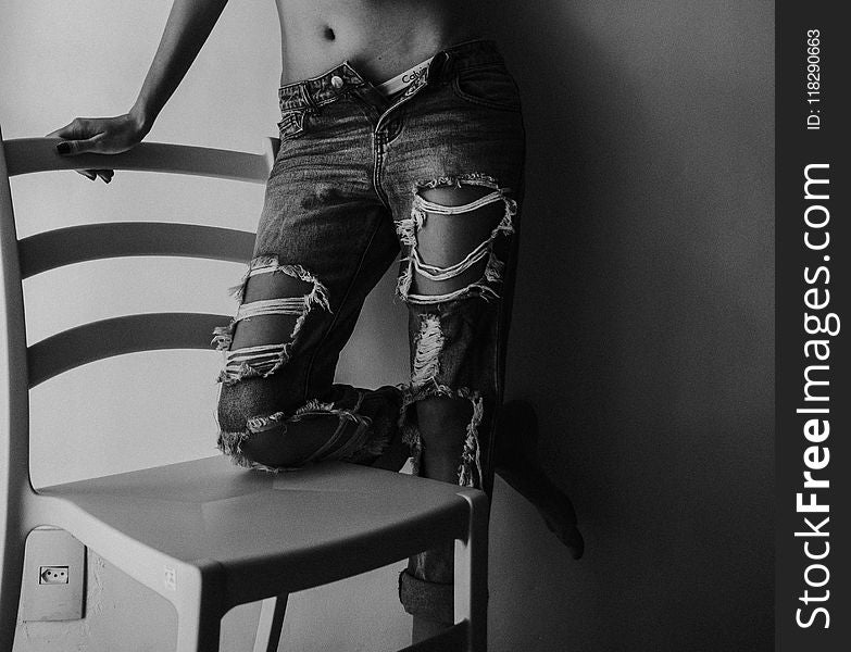 Grayscale Photography Of Person Wearing Distressed Jeans