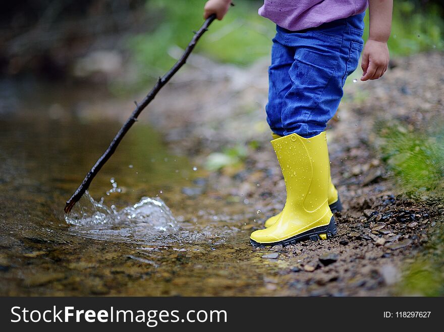 Two pairs of color children`s gumboots standing children. Walk in color rubber children`s boots