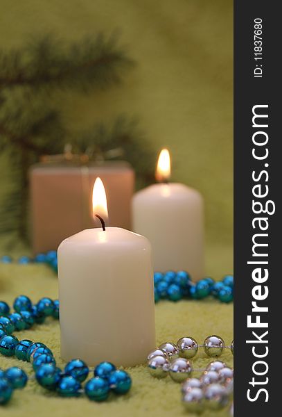 Christmas candles and glassbead on green background. Christmas candles and glassbead on green background