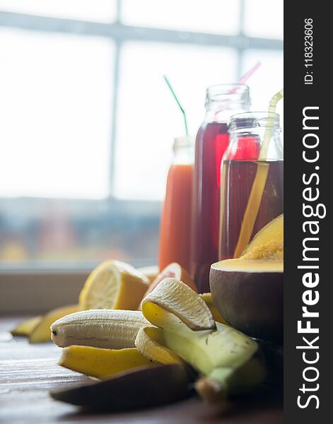 Delicious array of fresh fruit juices served in tall glasses made from liquidised orange, kiwifruit with peppermint, and strawberr