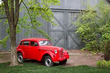 Red Retro Small Vintage Car Standing In The Garden In The Summer Royalty Free Stock Photography