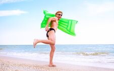 Crazy Happy Man With Swimming Mattress Runs In The Sea Stock Photography