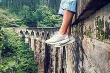 Woman Sits On The Demodara Nine Arches Bridge In Ella, Sri Lanka Stock Image Woman Sits On The Demodara Nine Arches Bridge In Ella, Sri Lanka Stock Image
