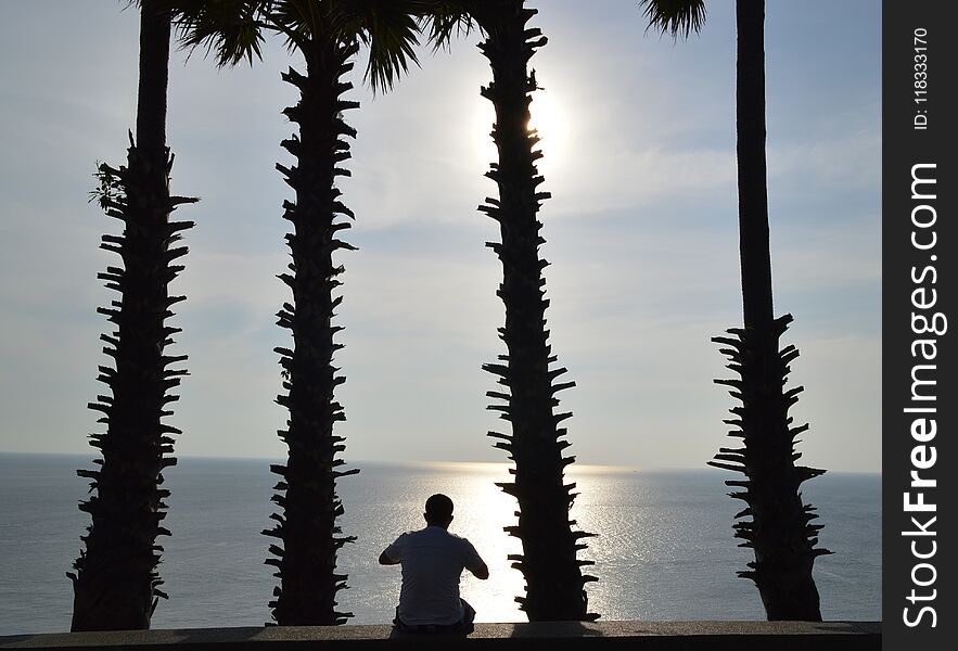 Sunset with a man, Phuket, The south of Thailand. It`s beautiful nature.