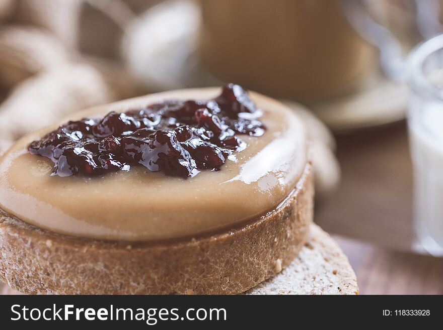 Organic Peanut Butter and Jelly Sandwich on Rustic Wooden Cutting Board. Healthy Breakfast.