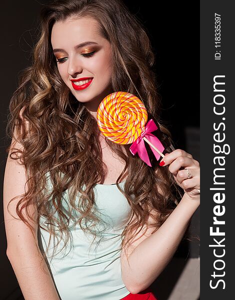Girl In Colorful Clothes Eats Colored Lollipop Tasty