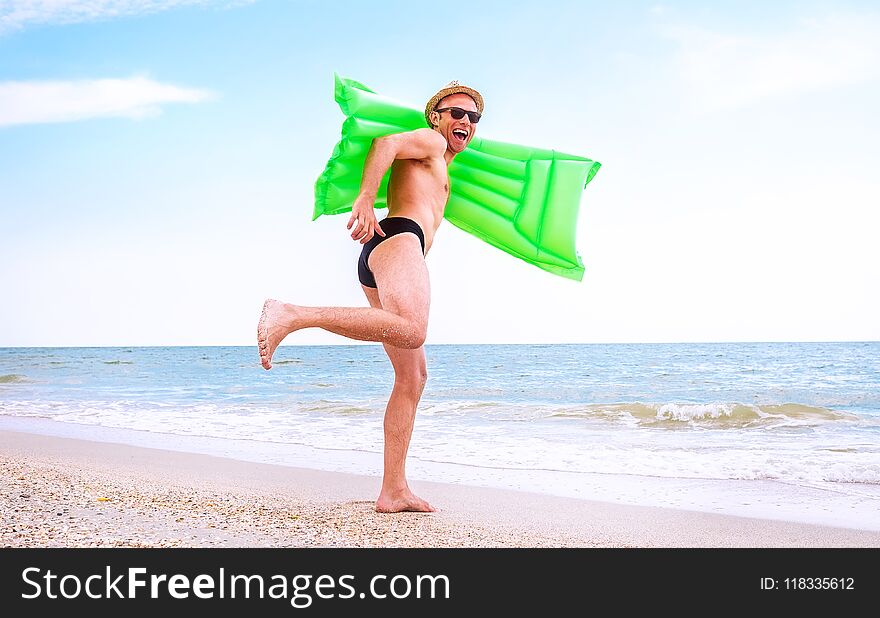 Crazy Happy Man With Swimming Mattress Runs In The Sea