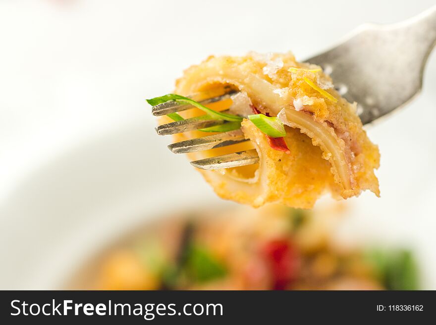 Fresh Fried Squids Calamari, Chili Pepper and Mint Leaves on White Plate. Sea Food.