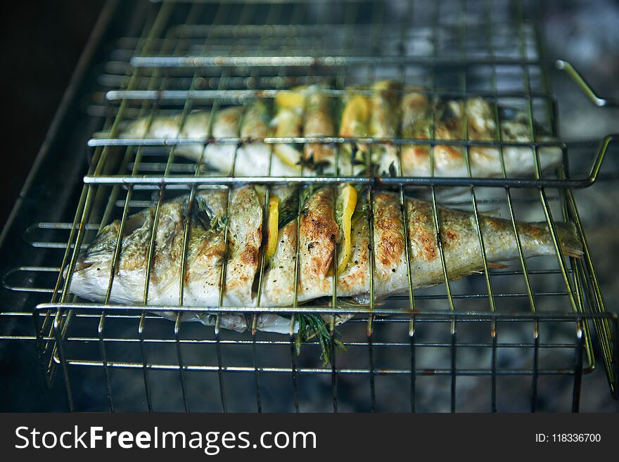 Sea bream prepared on grill with lemon and rosemary