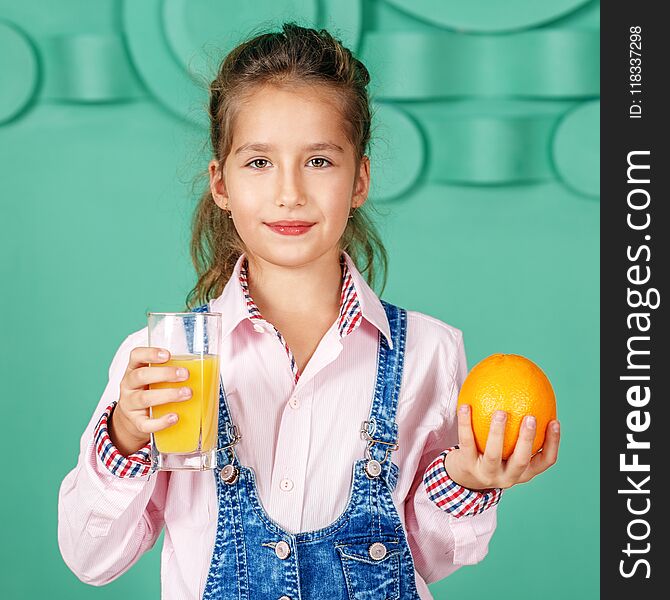 Kid girl drinks orange juice for breakfast. Square. The concept