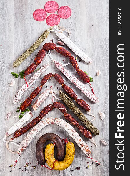 Christmas Tree Made Of Sausage On A Background Of A Wooden Wall