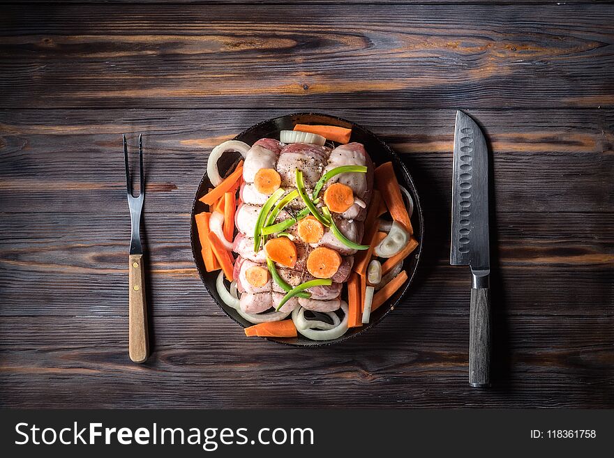 Raw pork chop marinated meat roll with assorted vegetables