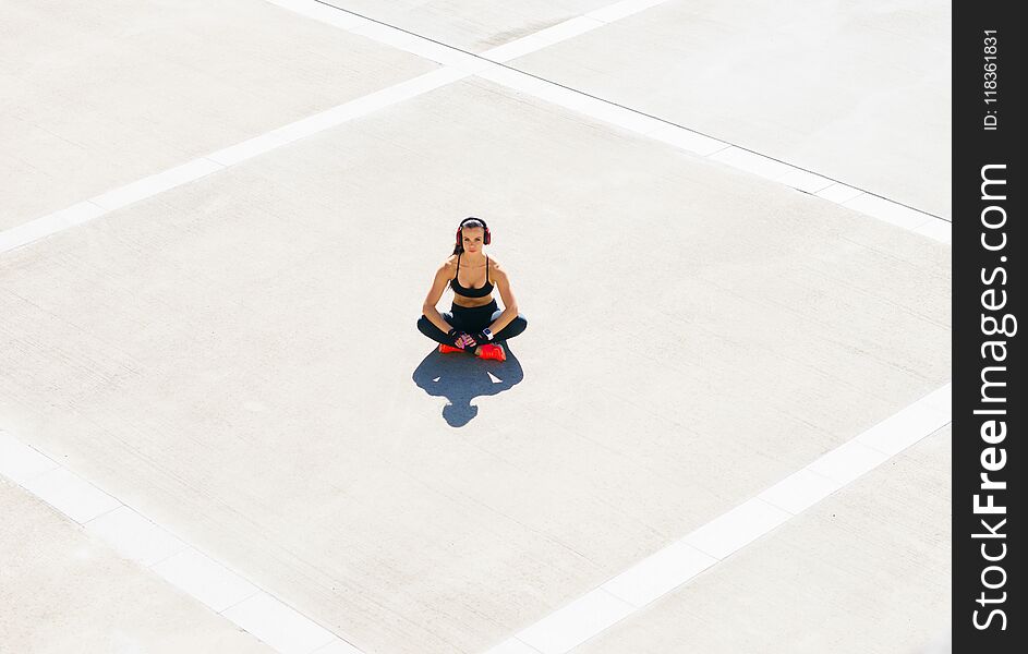 Young, fit and sporty woman preparing for urban jogging. Young, fit and sporty woman preparing for urban jogging.