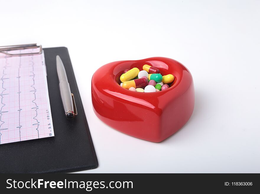 RX prescription, Red heart, asorted pils and a stethoscope on white background