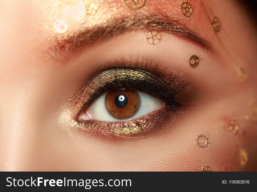 Beautiful woman eye with steampunk make-up close up macro