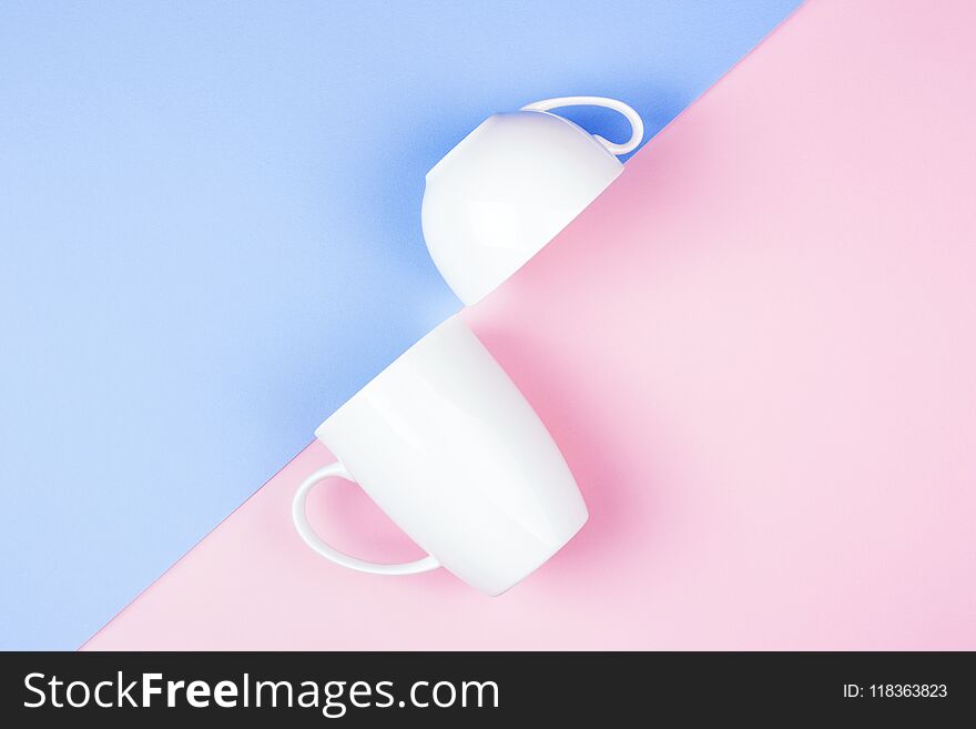 Geometric background with two white cups on colorful paper. Minimal styled design. Geometric background with two white cups on colorful paper. Minimal styled design.