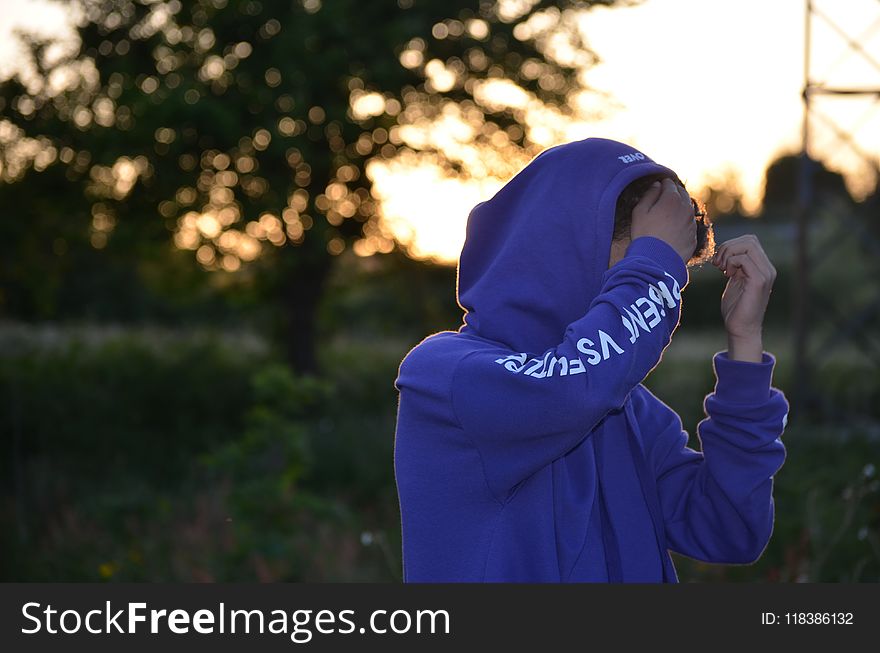 Shallow Focus Photo of Man in Blue Hoodie