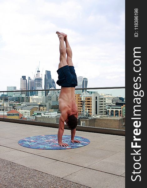 Man Wearing Black Shorts Doing Hand Stand