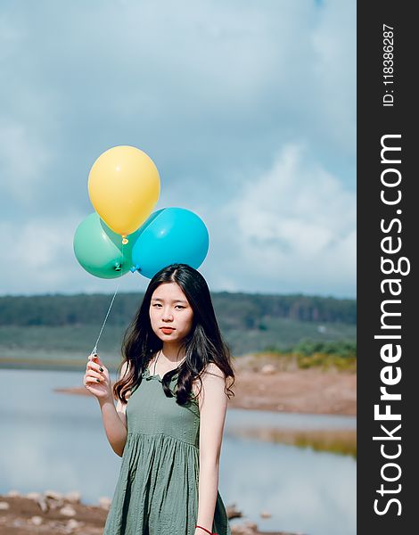 Woman Wearing Dress Holding Balloons