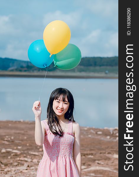 Photo of Woman Holding Balloons