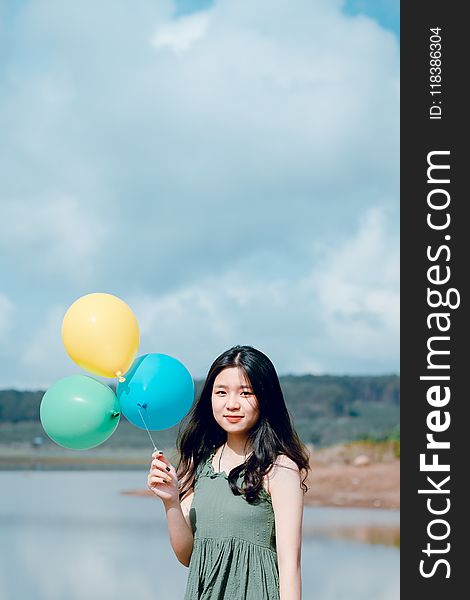 Woman In Green Sleeveless Top Holding Balloons