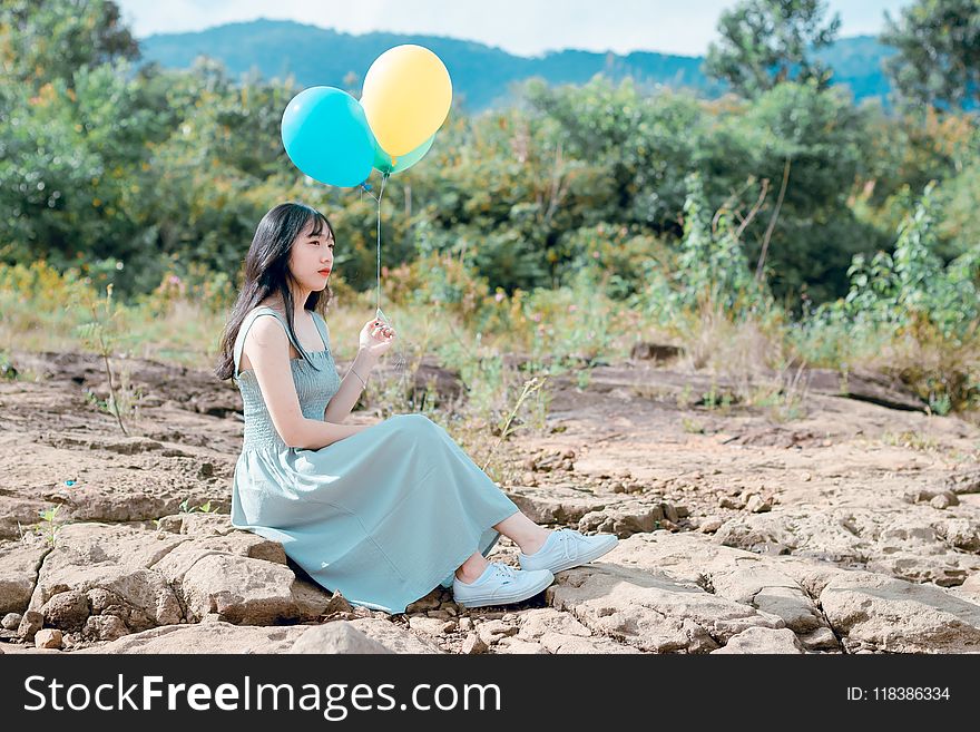 Woman Holding Balloons