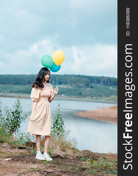 Woman Holding Balloons